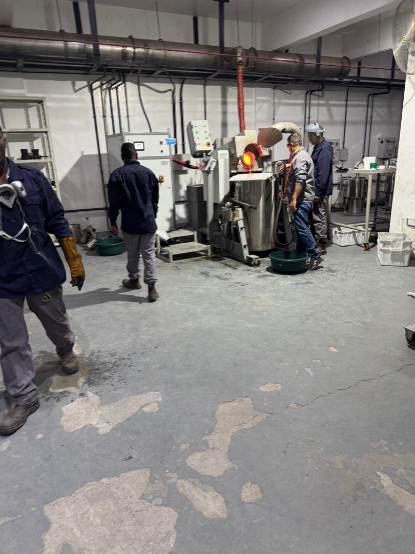 Refining floor smelting operation with workers in protective equipment